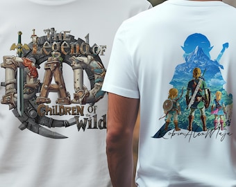 May include: White t-shirts with a graphic design. One shirt features the text "The Legend of Dad" with "Children of the Wild" and a sword and shield design. The other shirt has a colorful illustration of characters with a mountain backdrop.