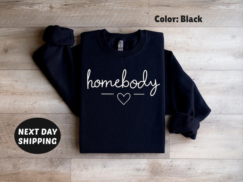 May include: Black sweatshirt with the text "homebody" in white lettering with a small heart in between two lines.
