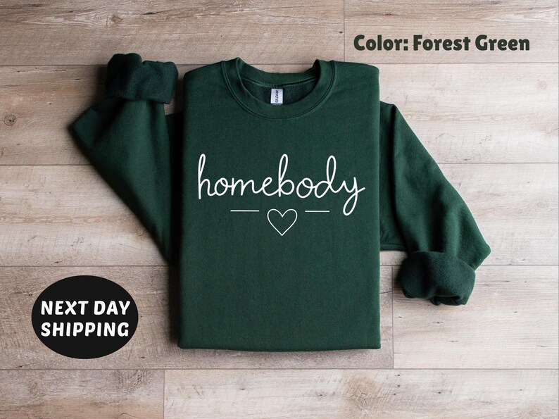 May include: Forest green sweatshirt with the text "homebody" in white lettering with a small heart in between the words.