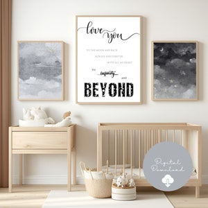 May include: Three framed art prints with a nursery theme. The central print reads "love you" and "to infinity and beyond." The other two prints feature watercolor cloud and celestial designs in shades of gray and white. The room includes a crib and wooden furniture.