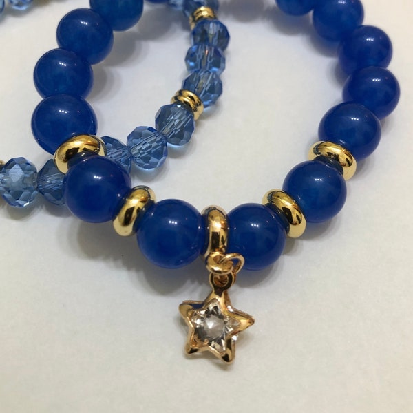 Two handmade blue and gold bracelets.  Blue Jade bracelet with star charm, and blue glass bracelet with 18K gold plated spacer beads