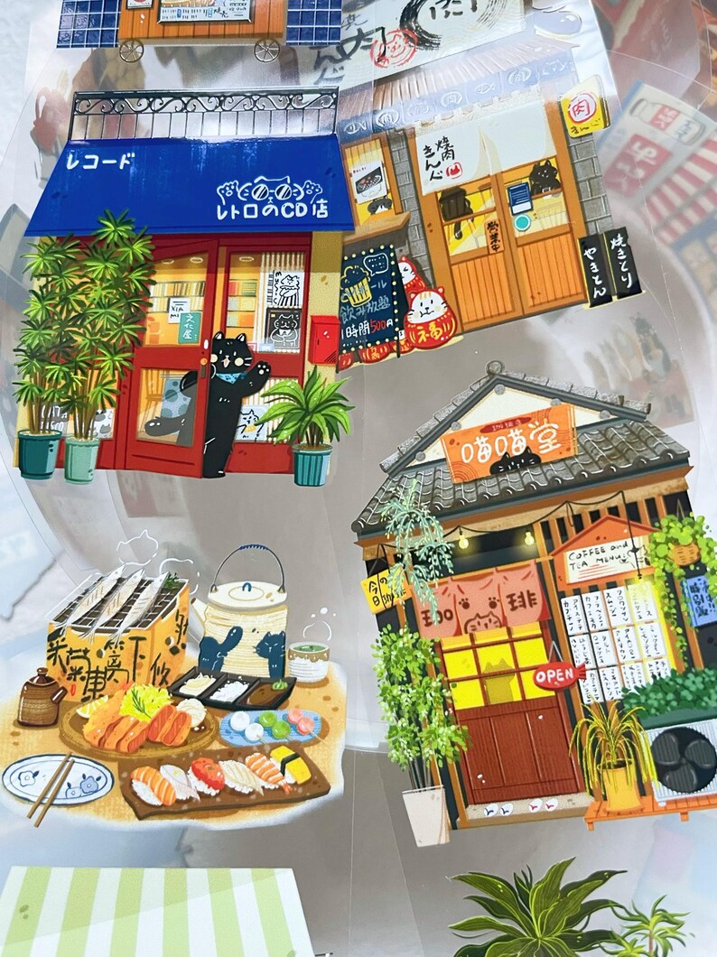 May include: A collection of colorful Japanese-themed stickers featuring illustrations of shops, restaurants, and food. The stickers include a record store, a yakitori restaurant, and a sushi display. The stickers have Japanese text and cartoon characters.