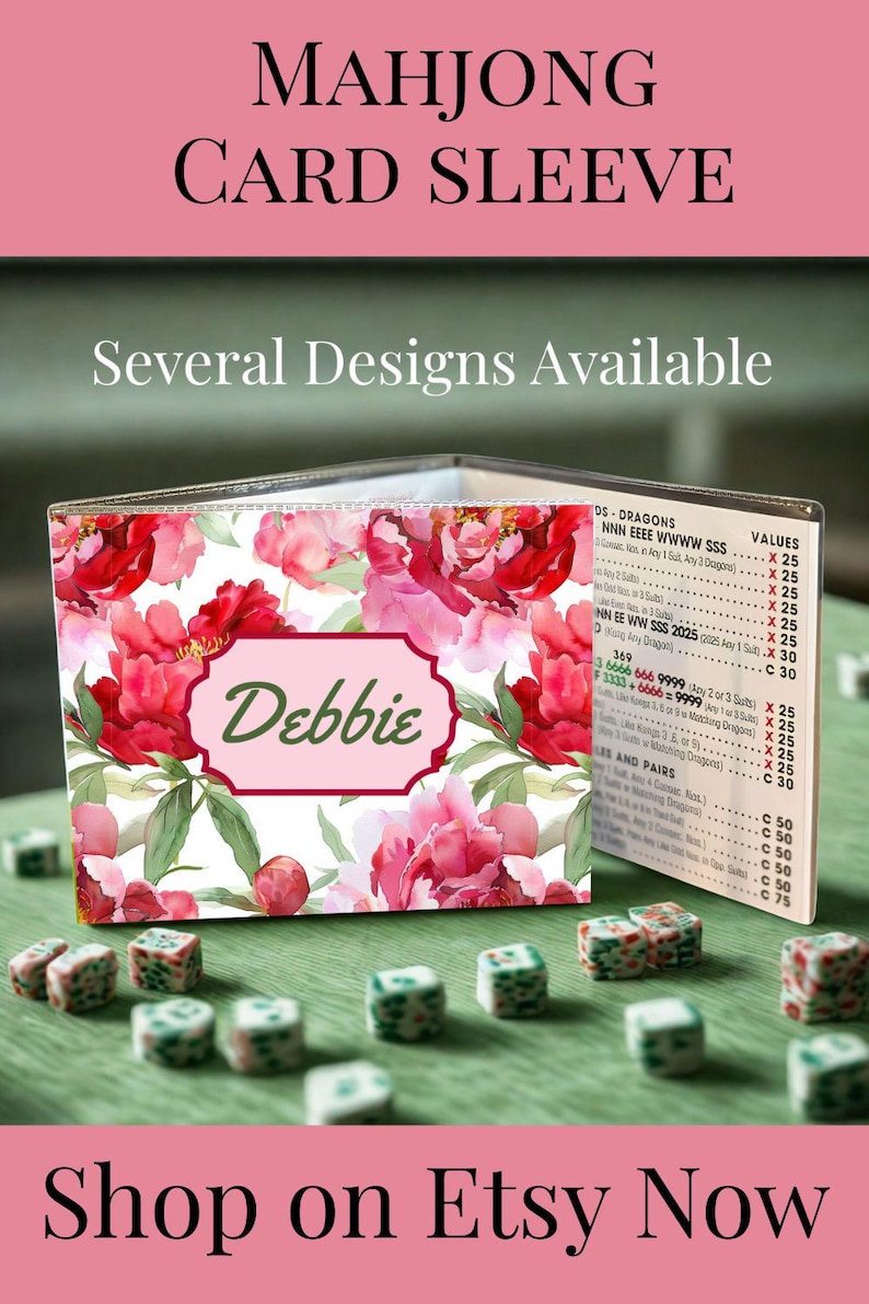May include: A clear plastic Mahjong card sleeve featuring a floral pattern of pink peonies and green leaves. A central rectangular label displays the name Debbie in green script. The sleeve holds a printed Mahjong score card with visible text.