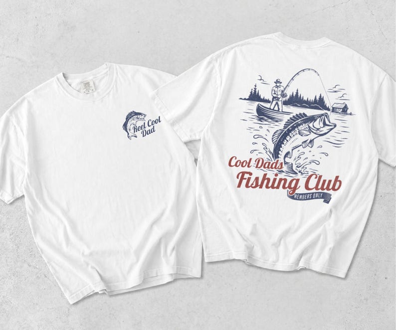 May include: White t-shirts with fishing-themed graphics. One shirt features a blue fish and the text "Reel Cool Dad." The other shirt displays a fisherman in a boat, a jumping fish, and the words "Cool Dads Fishing Club, Members Only."