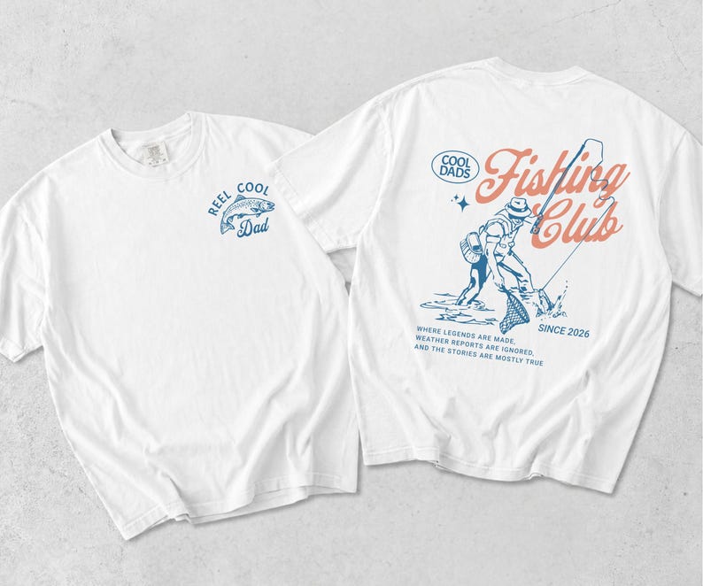 May include: Two white t-shirts with fishing-themed designs. One has a blue fish and the text "REEL COOL Dad." The other shows a fisherman, the words "Fishing Club," and "SINCE 2026." Additional text reads "WHERE LEGENDS ARE MADE..."