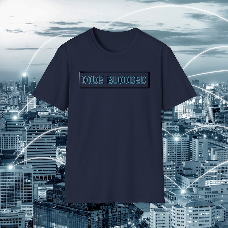 May include: Dark blue t-shirt displaying the text "CODE BLOODED" in a light blue, outlined font, within a rectangular frame. The background shows a cityscape with a network pattern.