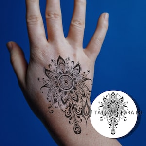 May include: Black and white mandala tattoo design with intricate details. The design features a central circle surrounded by a floral pattern.