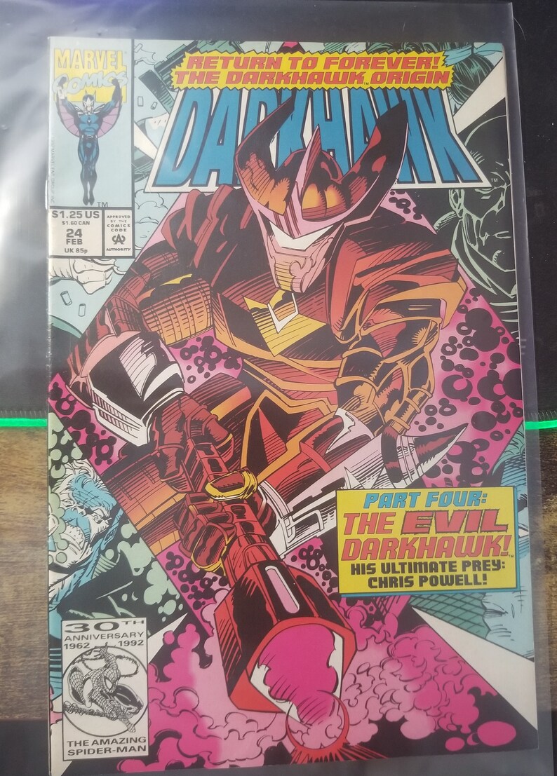 May include: A comic book cover featuring a red and black superhero character with a large, pointed helmet. The character is holding a large, glowing weapon. The cover text reads "Return to Forever! The Darkhawk Origin" and "Part Four: The Evil Darkhawk! His Ultimate Prey: Chris Powell!"