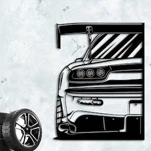 May include: Black and white silhouette of a sports car with a large rear wing. The car is facing the right side of the image and the rear lights are visible.