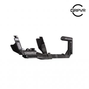 May include: A black plastic VR controller accessory featuring a textured grip handle, a central frame with two upright support arms, and a small rectangular textured inlay. The logo GRIPVR is printed in black in the upper right corner of the image.