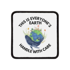 May include: White patch with black border featuring a blue whale holding a globe with green landmasses and blue oceans. The text reads "This is everyone's Earth handle with care".