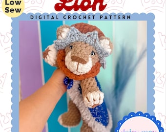 May include: A crocheted lion plushie named Archie, wearing a crown and a blue cape. The image includes text that reads "Archie The Lion DIGITAL CROCHET PATTERN" and "Low Sew". The plushie is part of the "TIMELESS PLUSHIE COLLECTION".