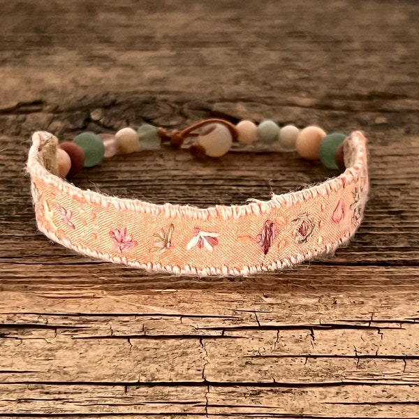 Hand embroidered silk bracelet with gemstone beads. Hand made using hand dyed cotton and upcycled sari silk ribbon and leather backing.
