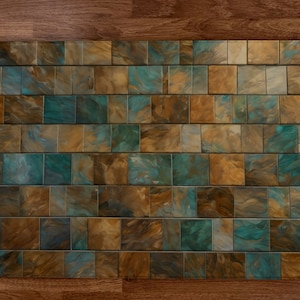 May include: A wall of small square tiles with a marbled pattern in shades of brown, gold, and teal.