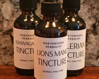 May include: Three glass bottles with dropper tops and white labels. The labels have black text that reads "Northwoods Herbalist" and the names of the tinctures: "Ashwagandha Tincture", "Lions Mane Tincture", and "Valerian Tincture".