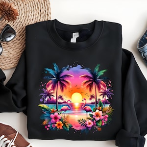 May include: Black sweatshirt with a colorful sunset scene featuring two pink flamingos, palm trees, and tropical flowers.