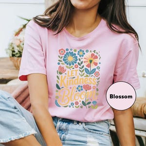 a woman sitting on a bench wearing a pink shirt