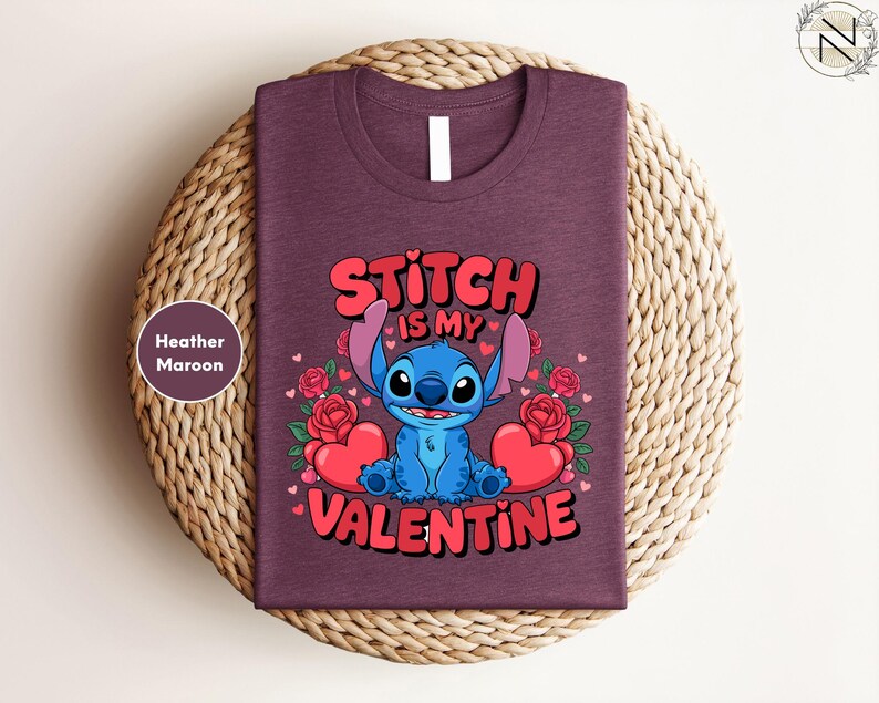 A purple t-shirt with a graphic design featuring a blue cartoon character and text that says "Stitch is my Valentine".