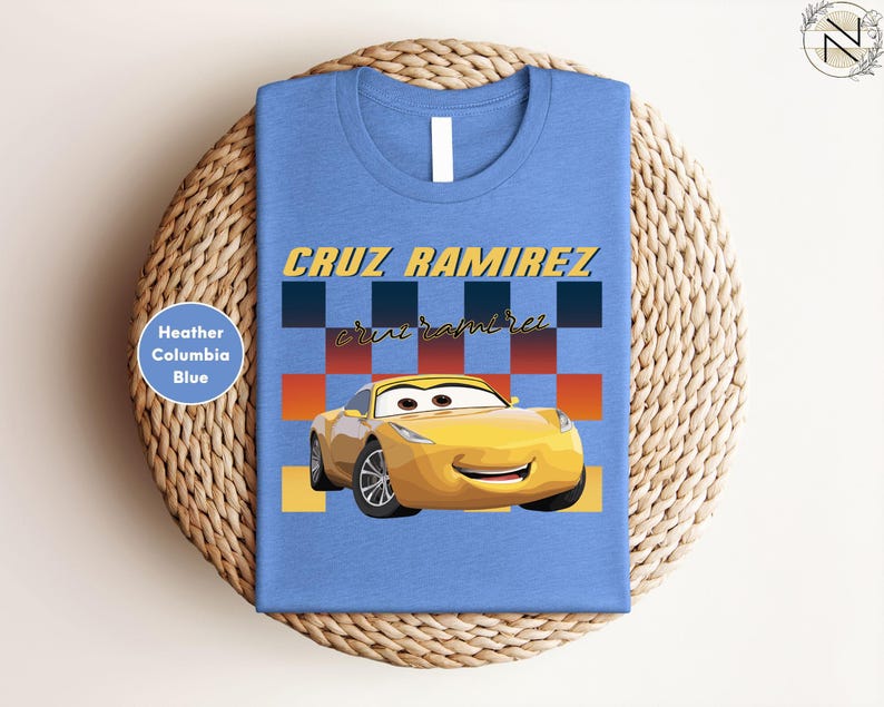 A blue t-shirt with a yellow car and the name "CRUZ RAMIREZ" printed on it, along with a checkered pattern.