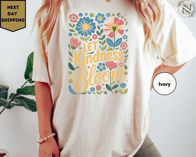 a woman wearing a t - shirt that says let kindness bloom
