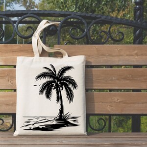 K&ouml;nnte beinhalten: Eine wei&szlig;e Einkaufstasche mit einer schwarzen Silhouette einer Palme am Strand. Die Palme hat Kokosn&uuml;sse.