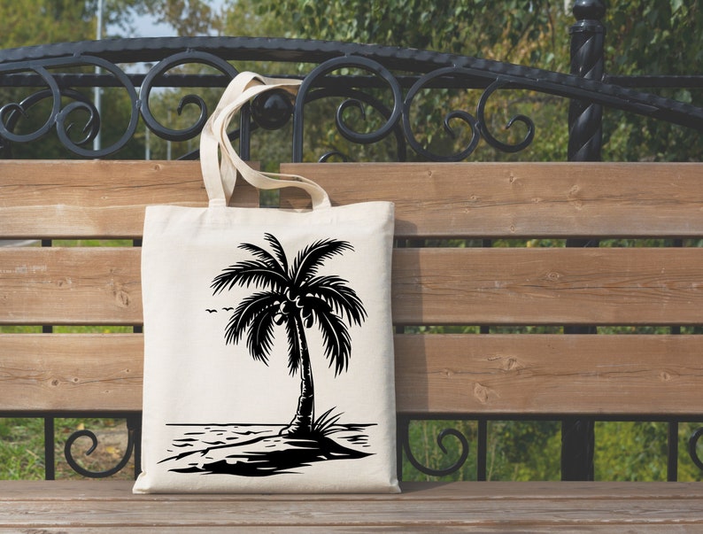 K&ouml;nnte beinhalten: Eine wei&szlig;e Einkaufstasche mit einer schwarzen Silhouette einer Palme am Strand. Die Palme hat Kokosn&uuml;sse.
