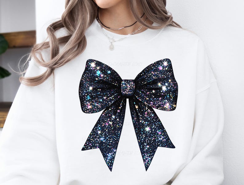 May include: White sweatshirt with a large black sparkly bow on the front.
