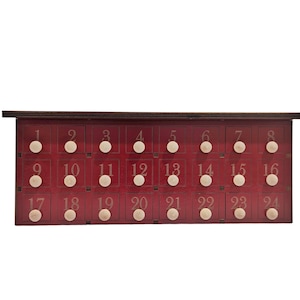 May include: A red wooden advent calendar with 24 numbered doors. Each door has a white knob. The numbers 1 through 24 are printed on the doors.
