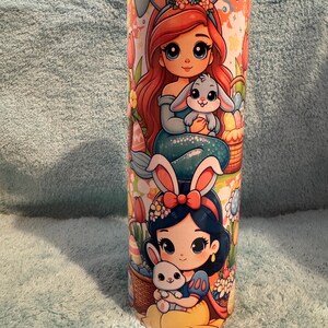 May include: A white ceramic mug with a black handle and the text "But First, Coffee" in a bold, black font. The mug is set against a neutral background, highlighting its simple design.