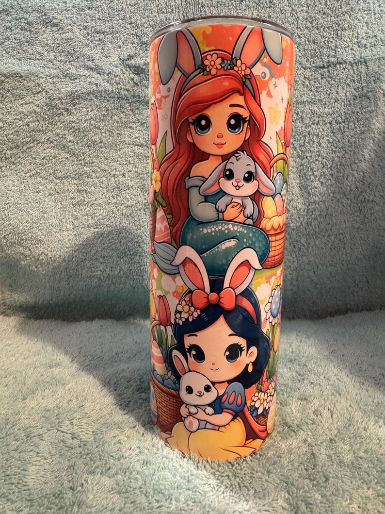 May include: A white ceramic mug with a black handle and the text "But First, Coffee" in a bold, black font. The mug is set against a neutral background, highlighting its simple design.