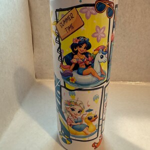 May include: A white stainless steel tumbler with a summer theme featuring Disney princesses. The tumbler has a blue lid and a variety of images including princesses, unicorns, and a duck. The text "Summer Time" is on a wooden sign.