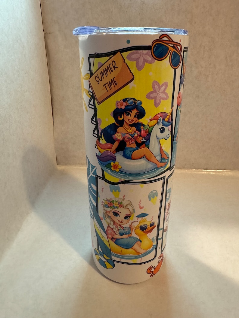 May include: A white stainless steel tumbler with a summer theme featuring Disney princesses. The tumbler has a blue lid and a variety of images including princesses, unicorns, and a duck. The text "Summer Time" is on a wooden sign.