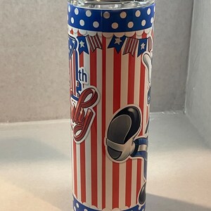 Peut inclure: Un gobelet isotherme rouge, blanc et bleu avec un personnage de dessin anim&eacute; et le texte "4th of July" dessus.
