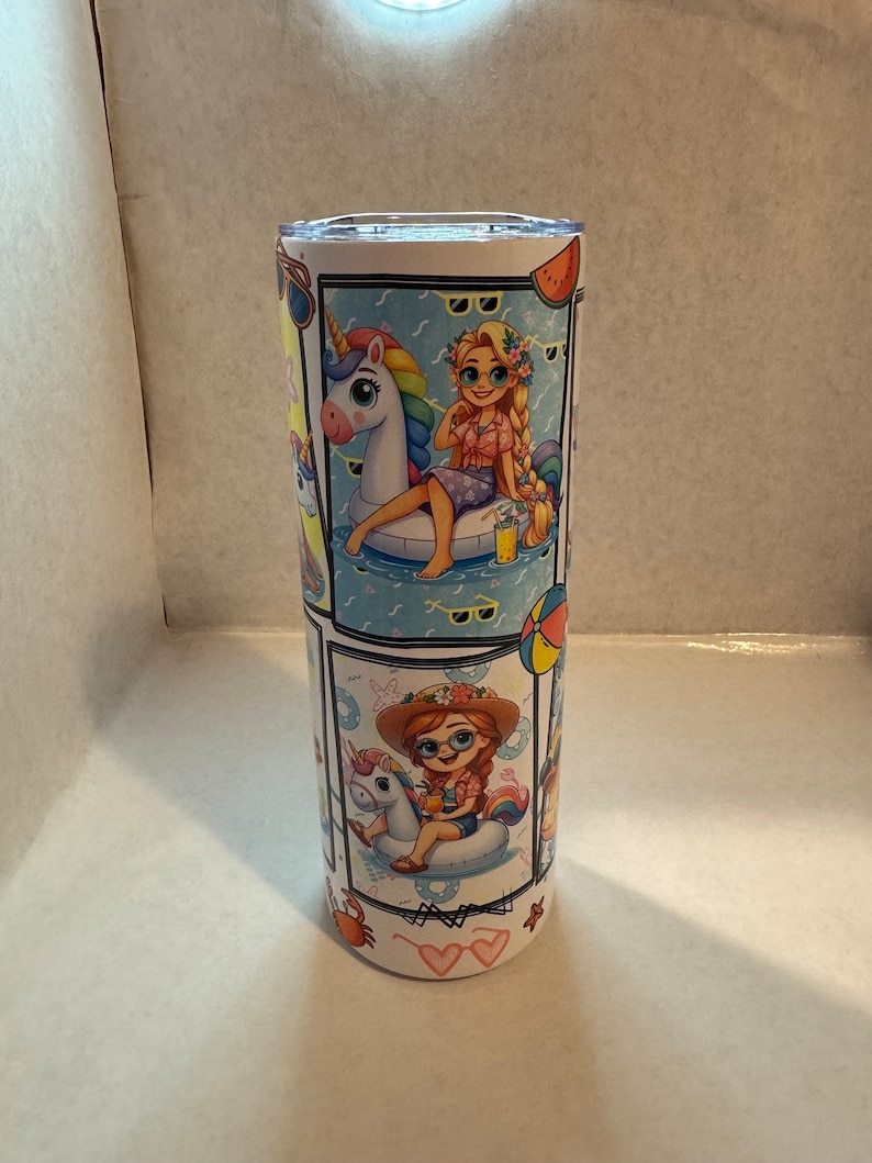 May include: A white stainless steel tumbler with a colourful design featuring a girl with long blonde hair wearing sunglasses and a pink shirt riding a unicorn float in a pool. The tumbler also features a girl with red hair wearing a straw hat and sunglasses riding a unicorn float in a pool. The tumbler has a white background with blue and white waves and other summer-themed designs.