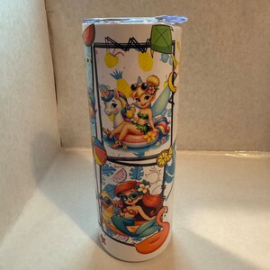 May include: A white stainless steel tumbler with a colourful design featuring cartoon characters. The design includes a mermaid, a fairy, and a unicorn. The characters are all wearing sunglasses and enjoying the summer.