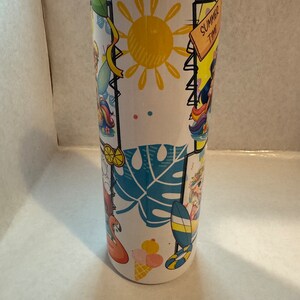 May include: White stainless steel tumbler with a summer theme design. The design features a yellow sun, blue palm leaves, pink flamingos, and colourful cartoon characters. The text "Summer Time" is on a wooden sign.