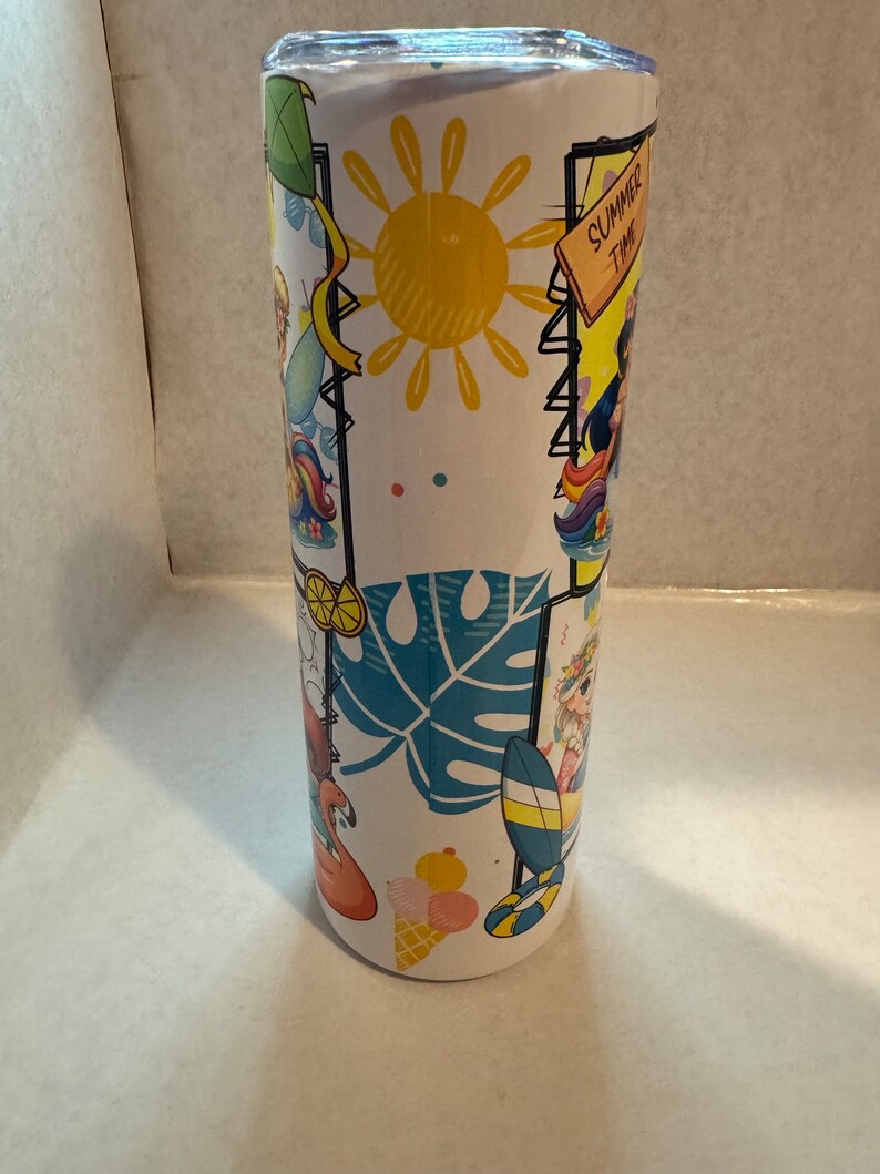 May include: White stainless steel tumbler with a summer theme design. The design features a yellow sun, blue palm leaves, pink flamingos, and colourful cartoon characters. The text "Summer Time" is on a wooden sign.