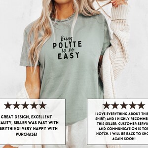 May include: A light green t-shirt with the text "Being Polite is so Easy" in black. The shirt is being worn by a person. Two five-star reviews are shown below the image. The first review says "Great design, excellent quality, seller was fast with everything! Very happy with purchase!" The second review says "I love everything about this t-shirt; and I highly recommend this seller. Customer service and communication is top notch. I will be back to shop again soon!"