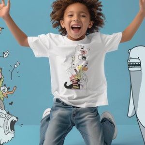 May include: A white t-shirt featuring a colorful cartoon illustration of stacked, whimsical creatures. The design includes various animal-like characters with expressive faces. The background is a light blue, and the image shows a child wearing the shirt.