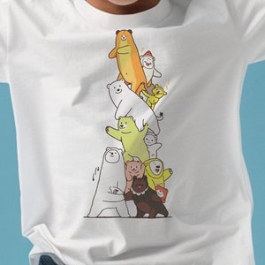 May include: White t-shirt featuring a stack of cartoon bears in various colors, including brown, white, yellow, and green. The bears are arranged in a playful, vertical composition, creating a whimsical design suitable for children's apparel.