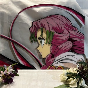 May include: A pink-haired anime character with green eyes and a white outfit is depicted in a colorful illustration. The character is surrounded by swirling lines of pink and white.