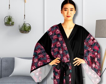 May include: A black and burgundy floral print robe with a long sleeve and a sash tie. The robe has a V-neck and a relaxed fit.