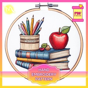 May include: A hand embroidery pattern featuring a stack of books, a red apple, and a pencil holder with coloured pencils. The pattern is in a circular hoop and is labelled "HAND EMBROIDERY PATTERN".