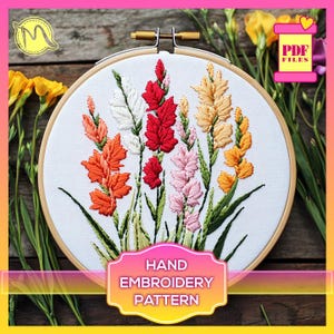 May include: A hand embroidery pattern featuring a bouquet of colorful gladiolus flowers in a wooden embroidery hoop. The pattern is available as a PDF download.