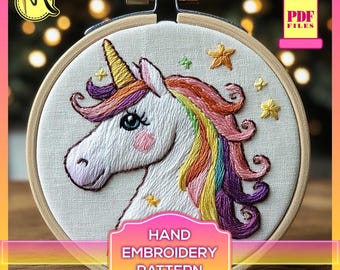 May include: A hand embroidery pattern featuring a white unicorn with a rainbow mane and tail. The unicorn is surrounded by small yellow stars on a white fabric background. The pattern is displayed in a wooden embroidery hoop.