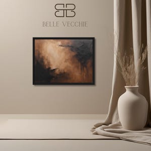 Puede incluir: Pintura abstracta en tonos marrones y negros, enmarcada en negro, colgada en una pared beige. La pintura está en un ambiente interior minimalista con un jarrón y una alfombra.