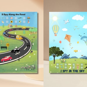 May include: Two printable I Spy game cards. The first card features a winding road with cars, a bus, a bicycle, a scooter, and a bench. The second card features a blue sky with a hot air balloon, a kite, a parachute, a plane, and clouds. Both cards have a grid of squares for counting.
