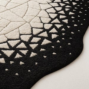 Close view of black cracked lines contrasted against ivory base in eclipse pattern.