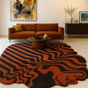 May include: A modern living room featuring a rug with an abstract, wavy pattern in orange and black. A brown sofa, wooden coffee table, and artwork are also visible, creating a stylish interior.