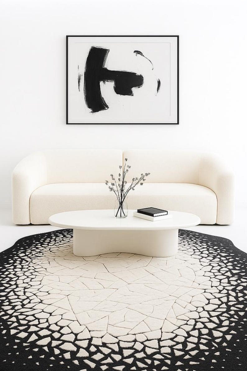 Close-up texture shot showing soft hand-tufted wool and silk blend fibers in black and ivory pattern.